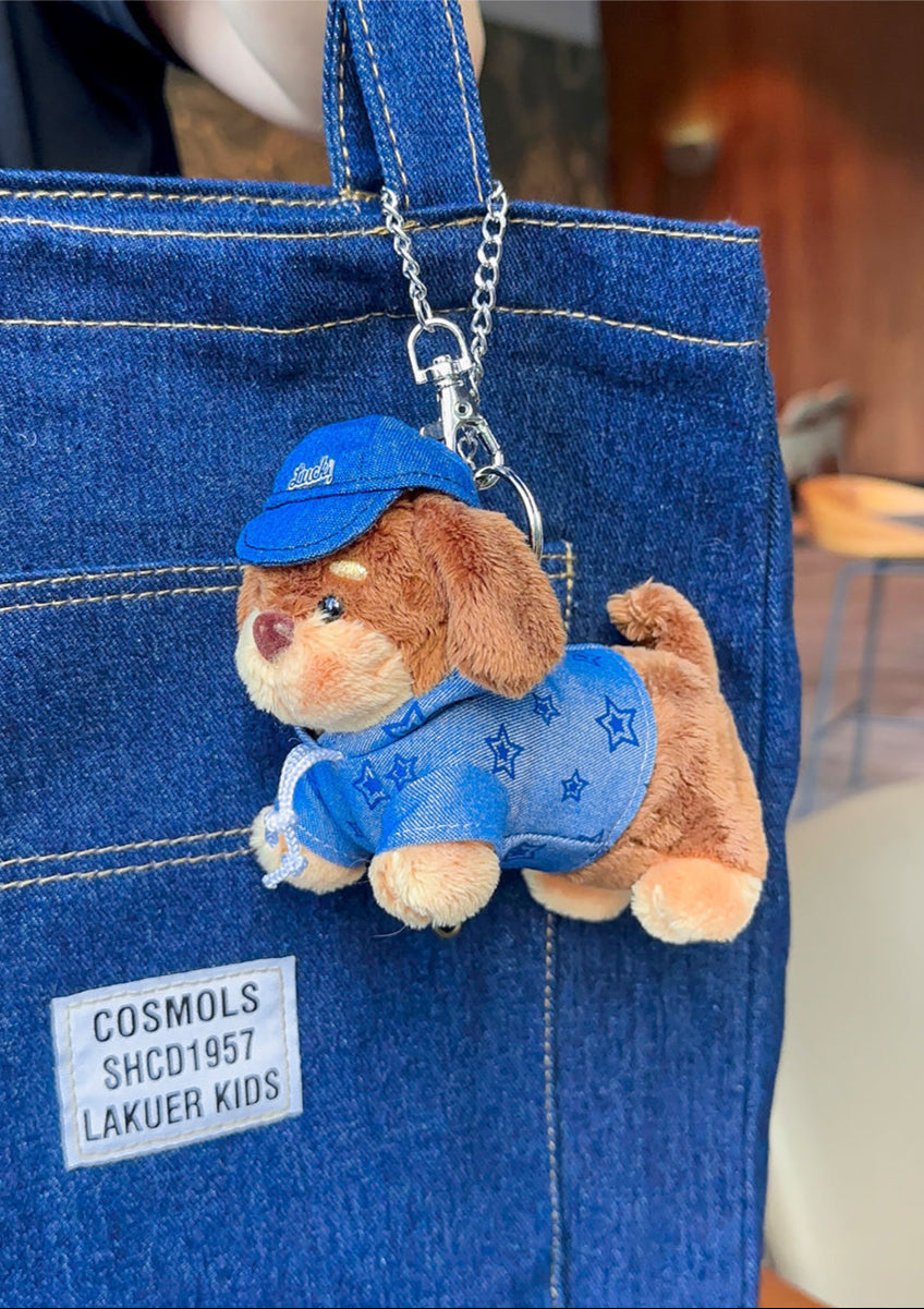 Handmade denim dachshund plushie bag charm with embroidered eyes and clip, adding playful texture to bags or backpacks.