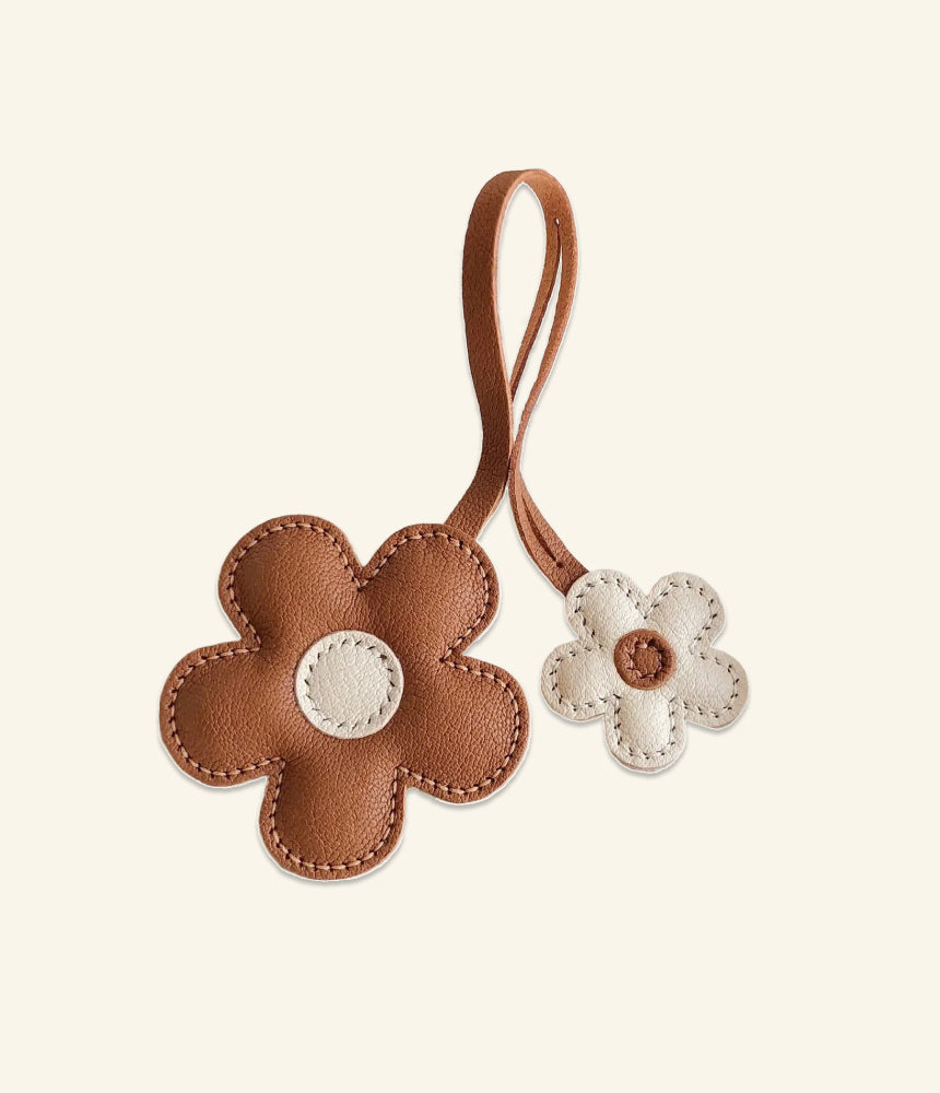 Handmade brown and white flower leather bag charm—crafted from supple leather with engraved details. A luxury yet elegant accessory for your bag. 