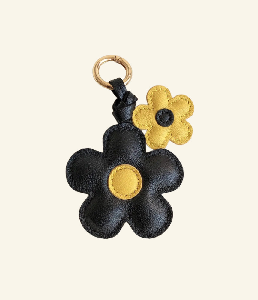 Handmade black and yellow flower leather bag charm—crafted from supple leather with engraved details. A luxury yet elegant accessory for your bag. 